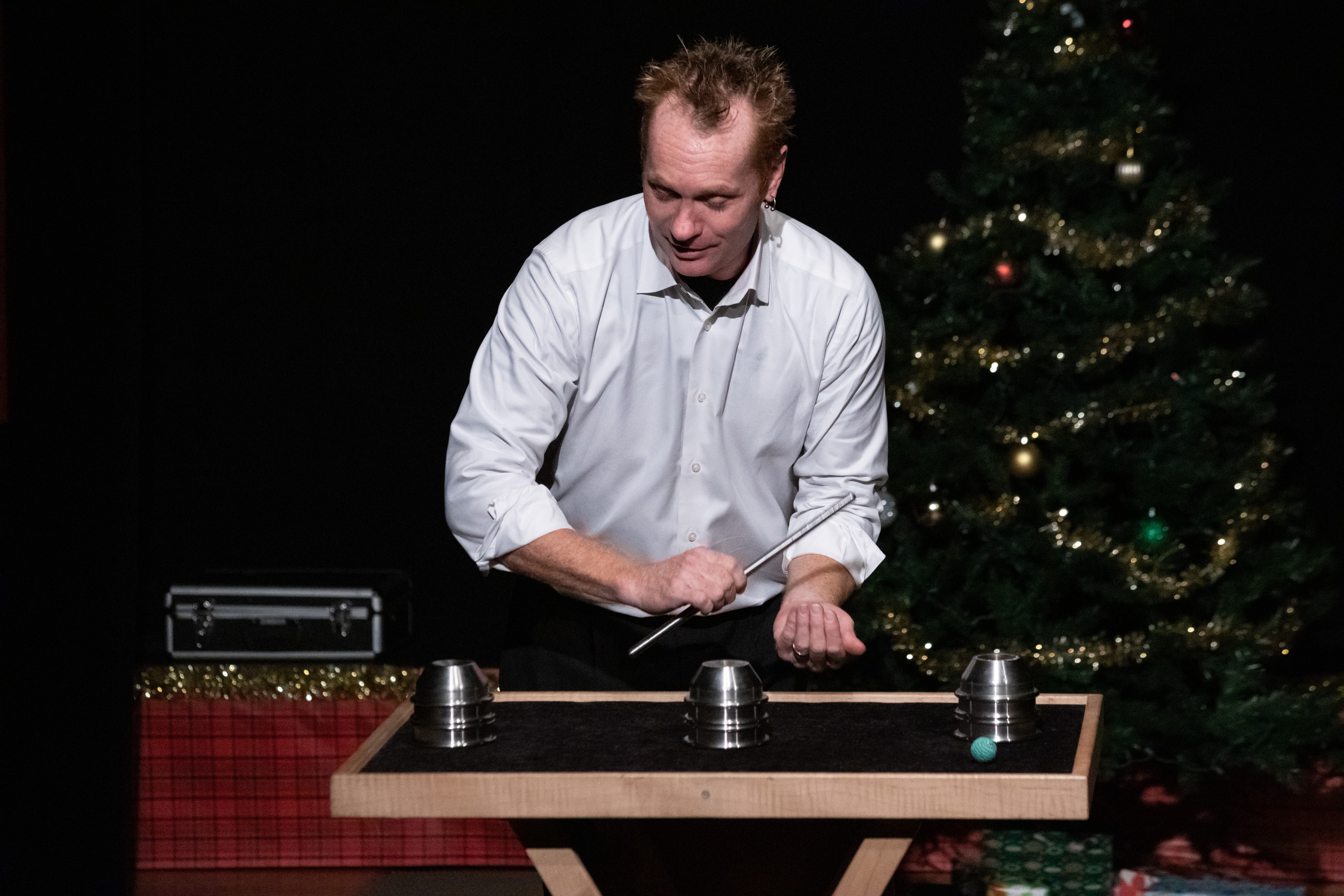 Kristian Charles performing shell game magic trick