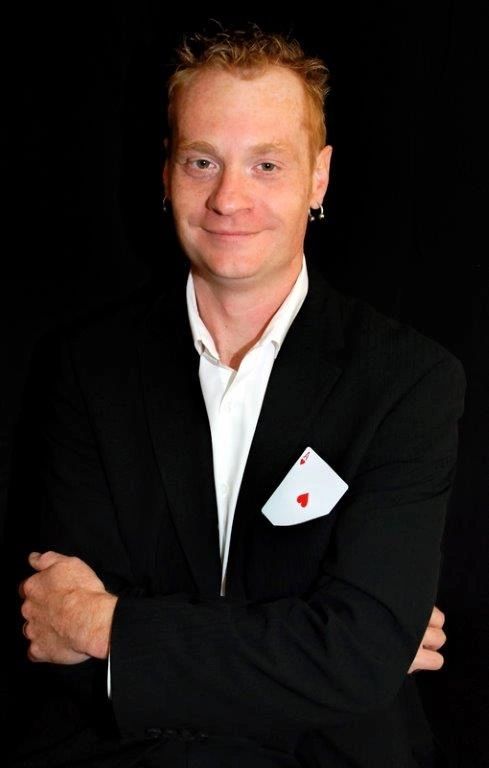 Kristian Charles professional headshot with playing card